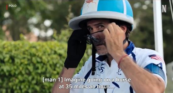 a man wearing a helmet and glasses is talking on a cell phone .