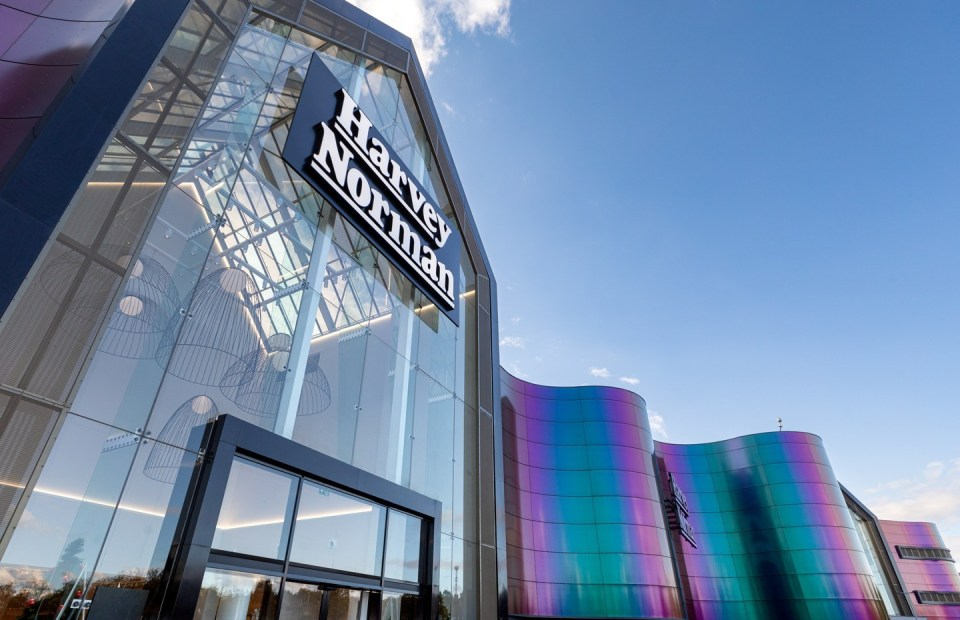 a large building with a sign that says harvey norman