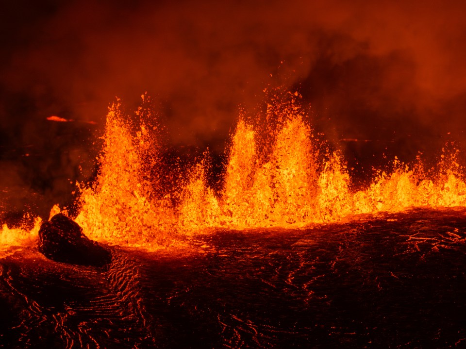 a large amount of lava is erupting into the air