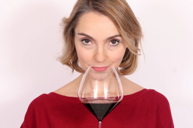 a woman with a glass of wine on her nose