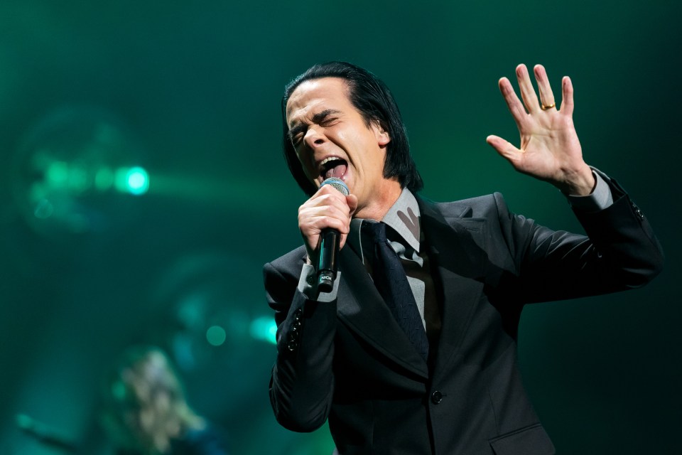 a man in a suit singing into a microphone