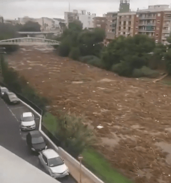 The trickle turns into a torrent with the water carrying logs and rubbish