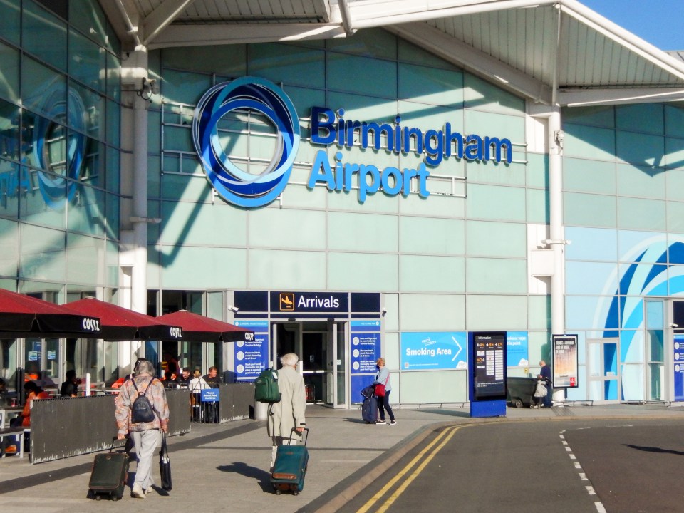 people walking in front of the birmingham airport