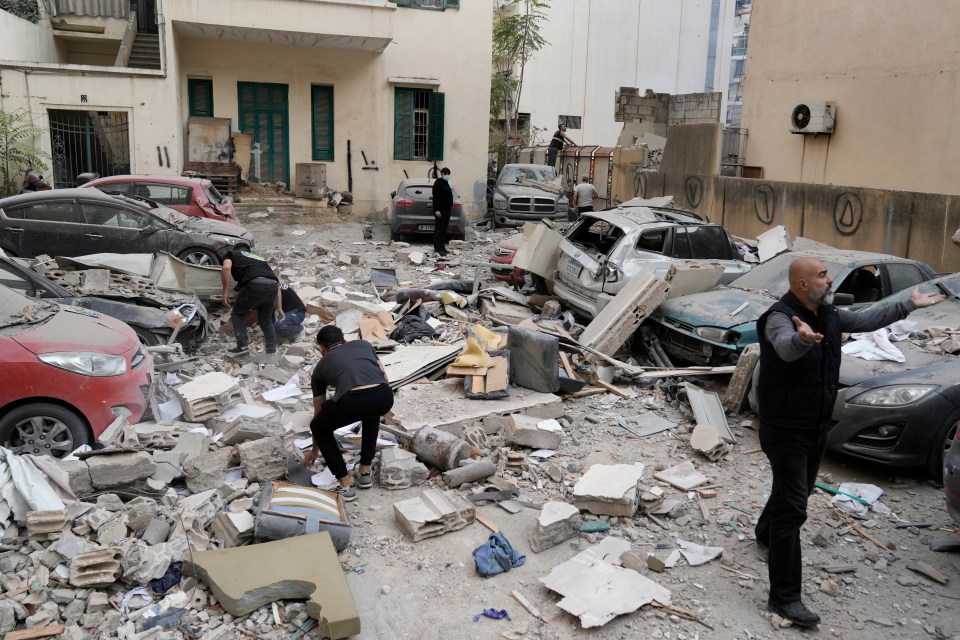 People search through the rubble of a destroyed building at the site of an Israeli airstrike in central Beirut’s Ras el-Nabaa neighbourhood in Lebanon on Sunday