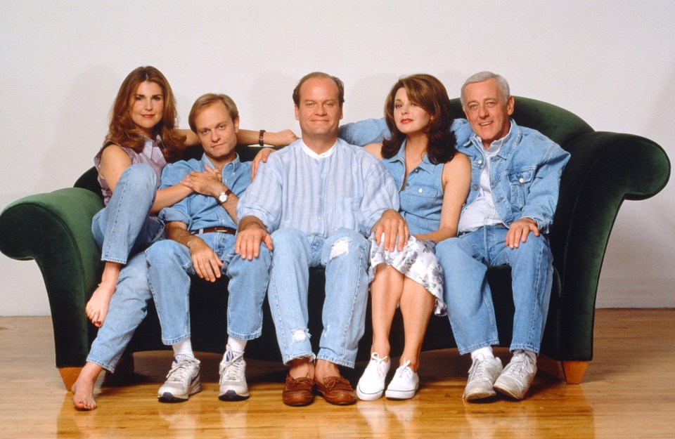 a group of people sitting on a green couch