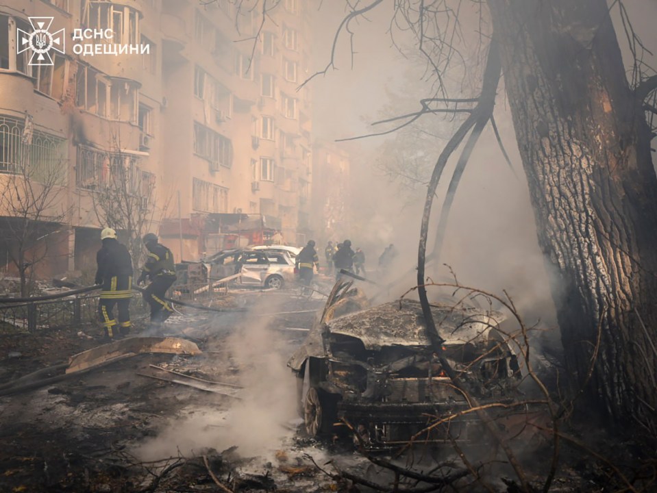 Emergency services personnel work to extinguish a fire following a Russian rocket attack in Odesa, Ukraine