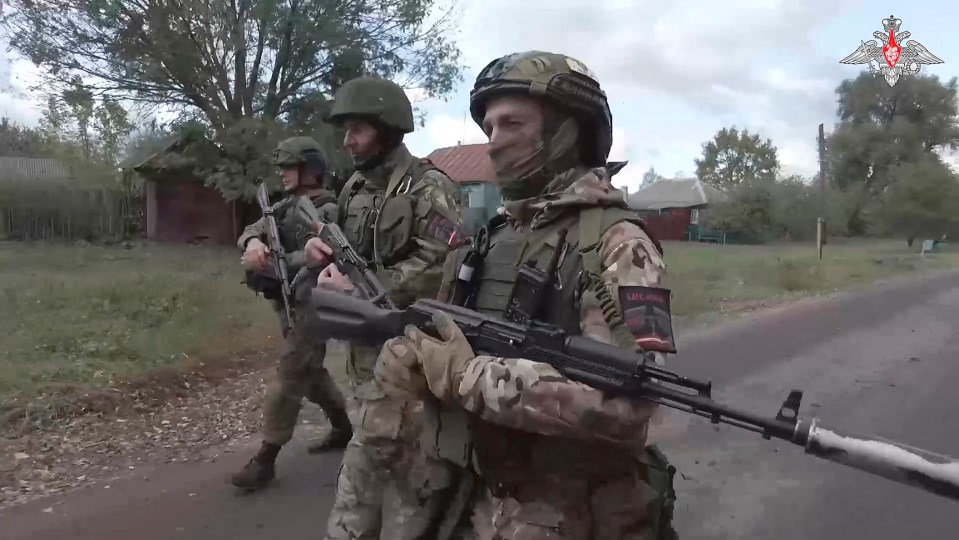 Russian soldiers patrol a village in the Russian - Ukrainian border area of Kursk