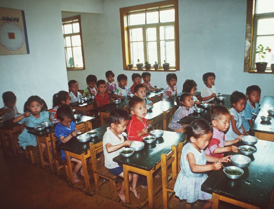 Youngsters eat food at a kindergarten in North Korea