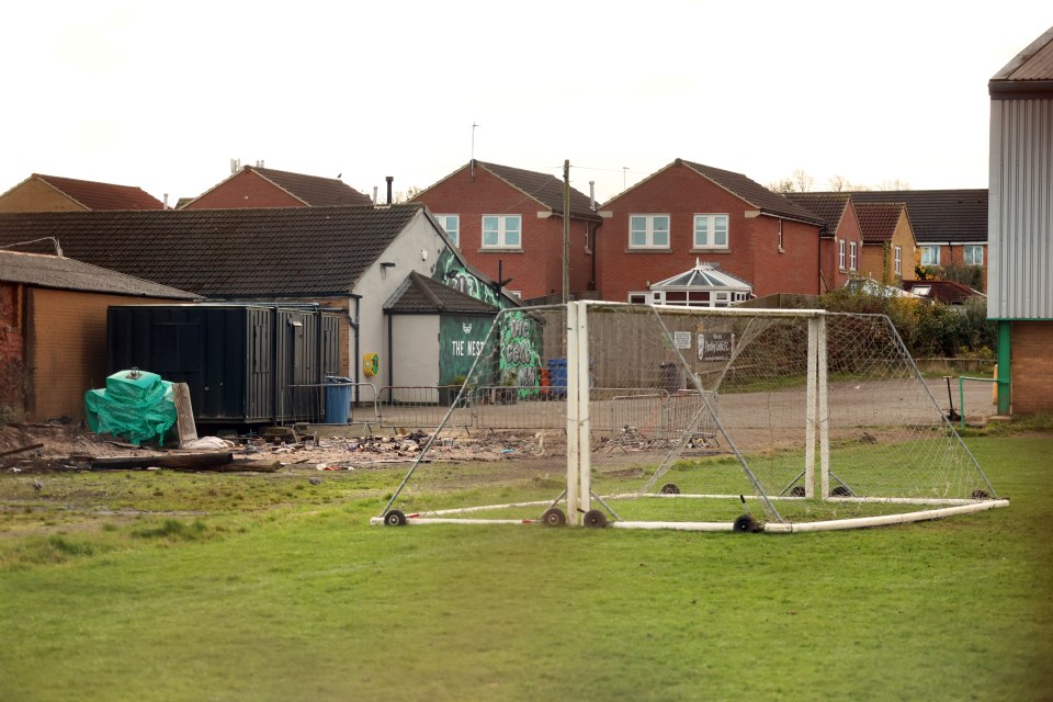 A lone goal can be seen on the rotting field