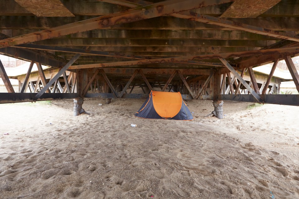 A homeless person's tent erected underneath the pier