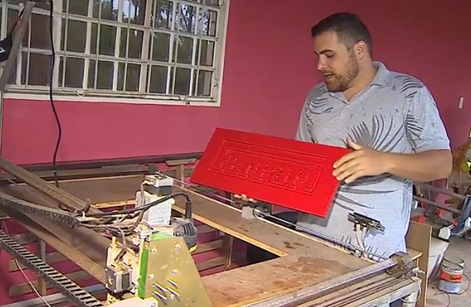 a man is holding a red box with the word ferrari on it