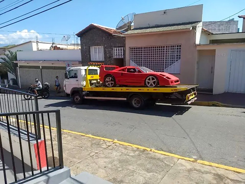 a red sports car is being towed by a tow truck