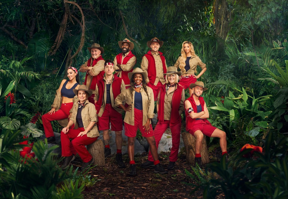 a group of people posing for a picture in the jungle