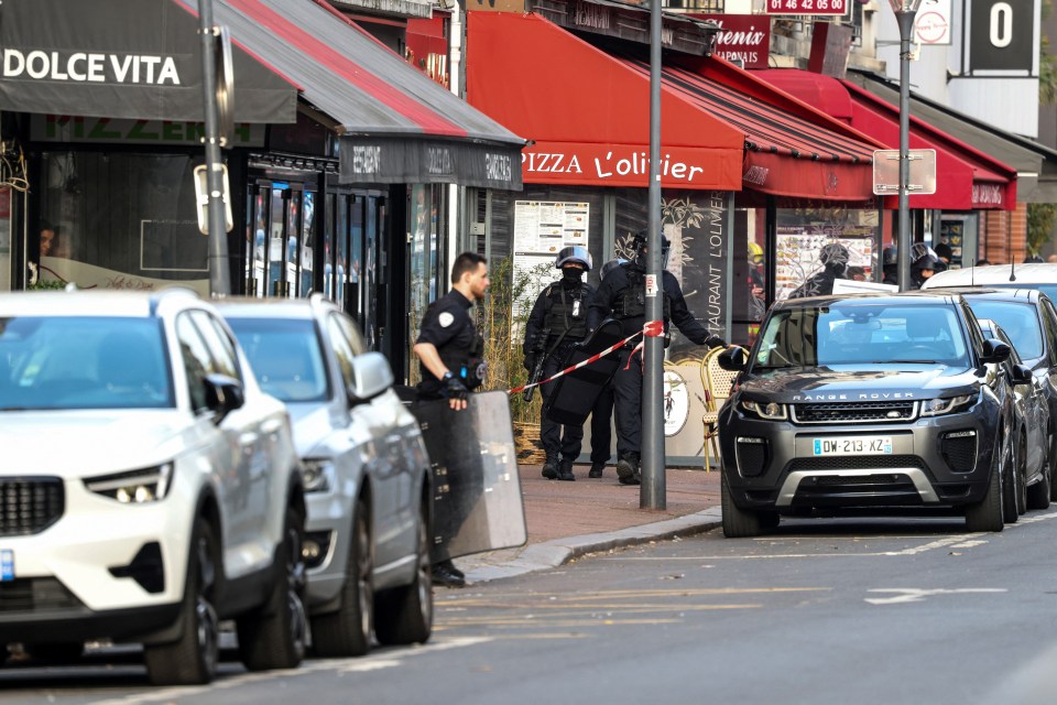 Police members work outside the pizza restaurant