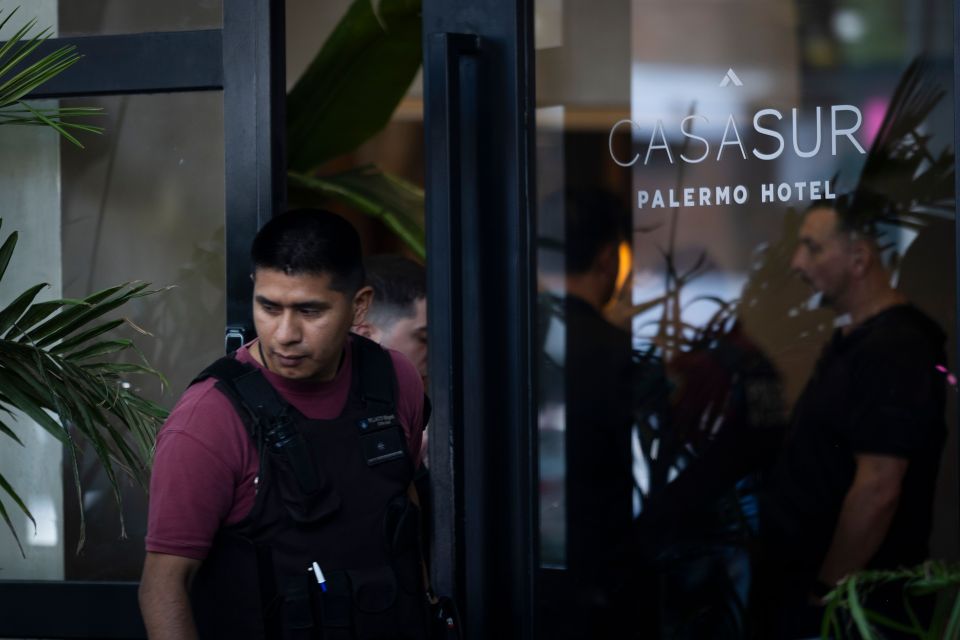 A police officer exits the hotel where Liam died