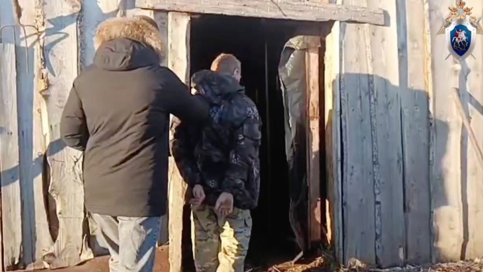 The alleged culprit being led into the barn by police following the significant breakthrough