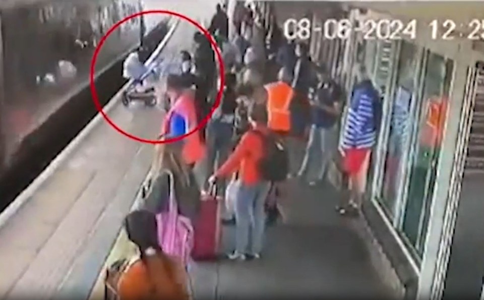 a group of people are standing on a train platform .