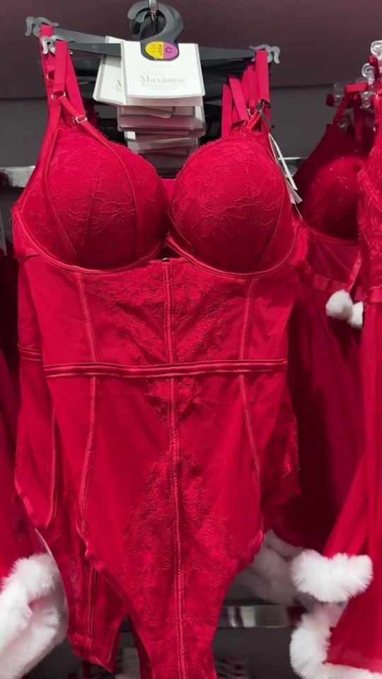 a red lace bodysuit with the word maximise on it