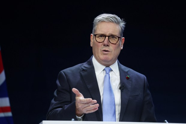 a man in a suit and tie is giving a speech