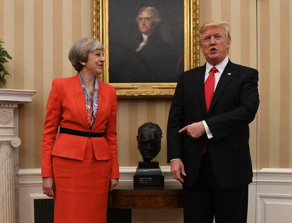 two people standing in front of a painting of george washington