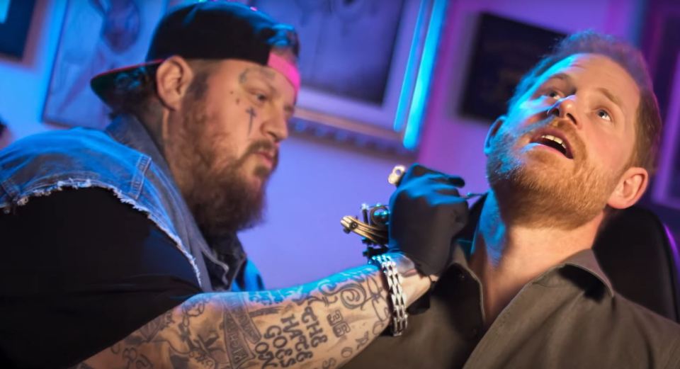 a man is getting a tattoo on his arm that says " i love you "