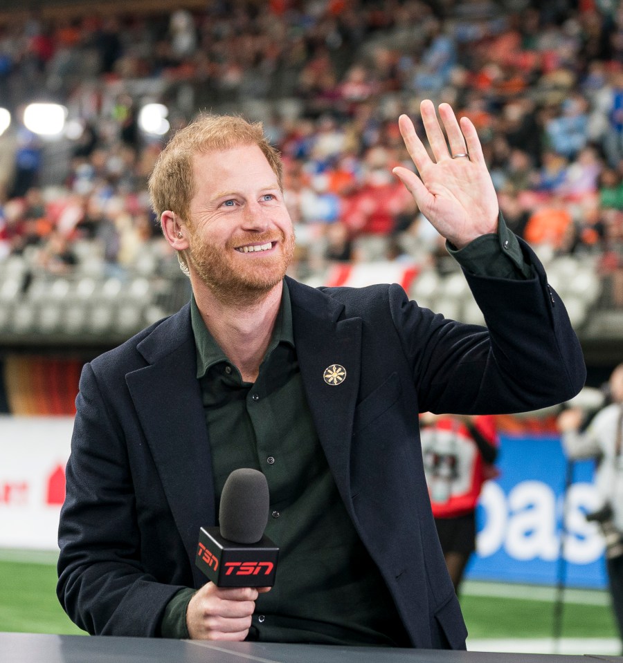 Prince Harry waves to fans prior to the start of a TV interview during pre-game festivities