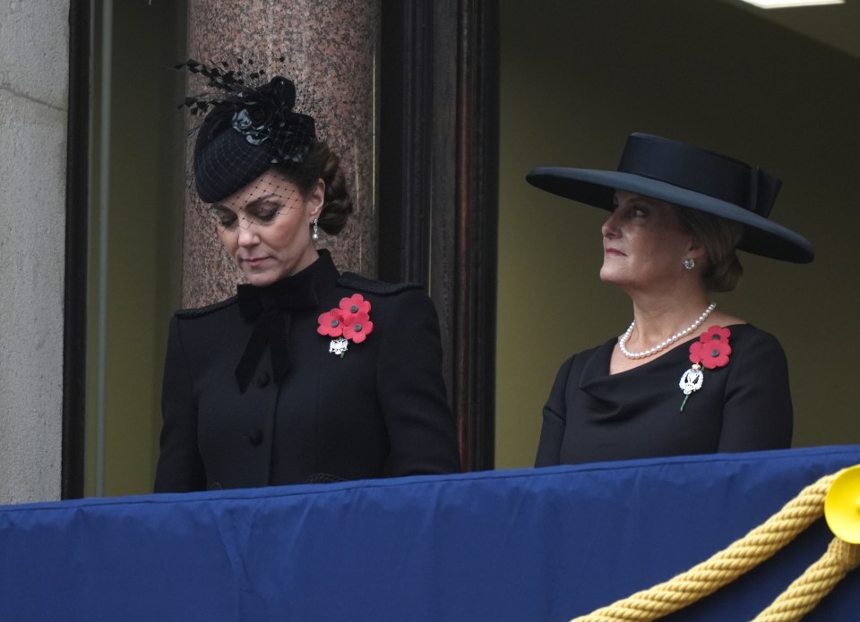 two women standing next to each other wearing black clothes and hats