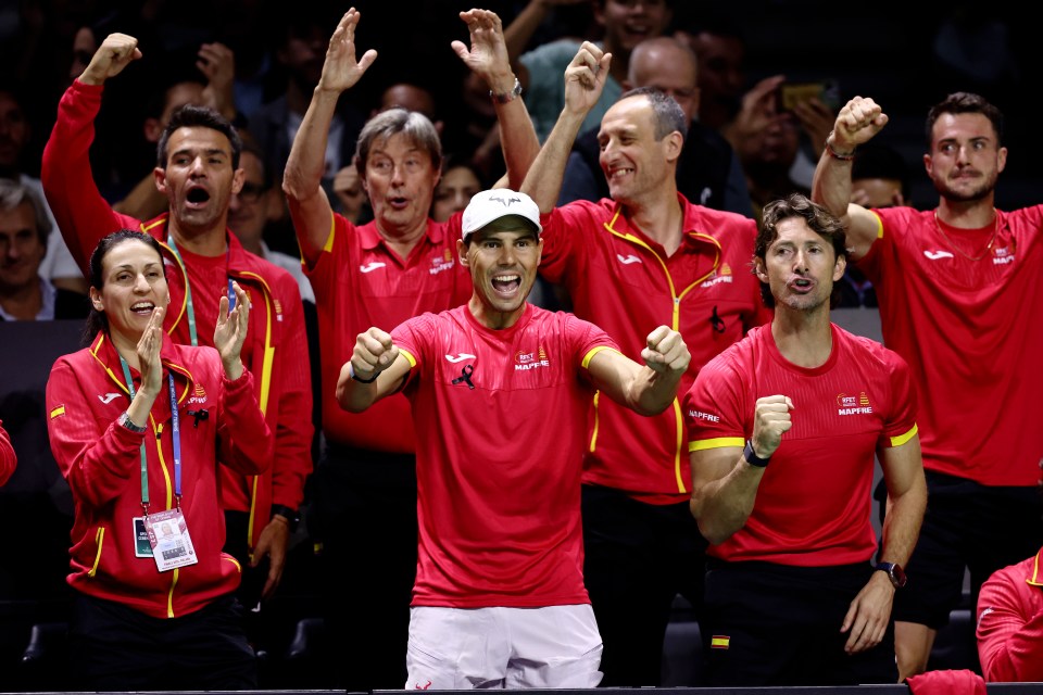 a man wearing a red shirt that says ' spain ' on it