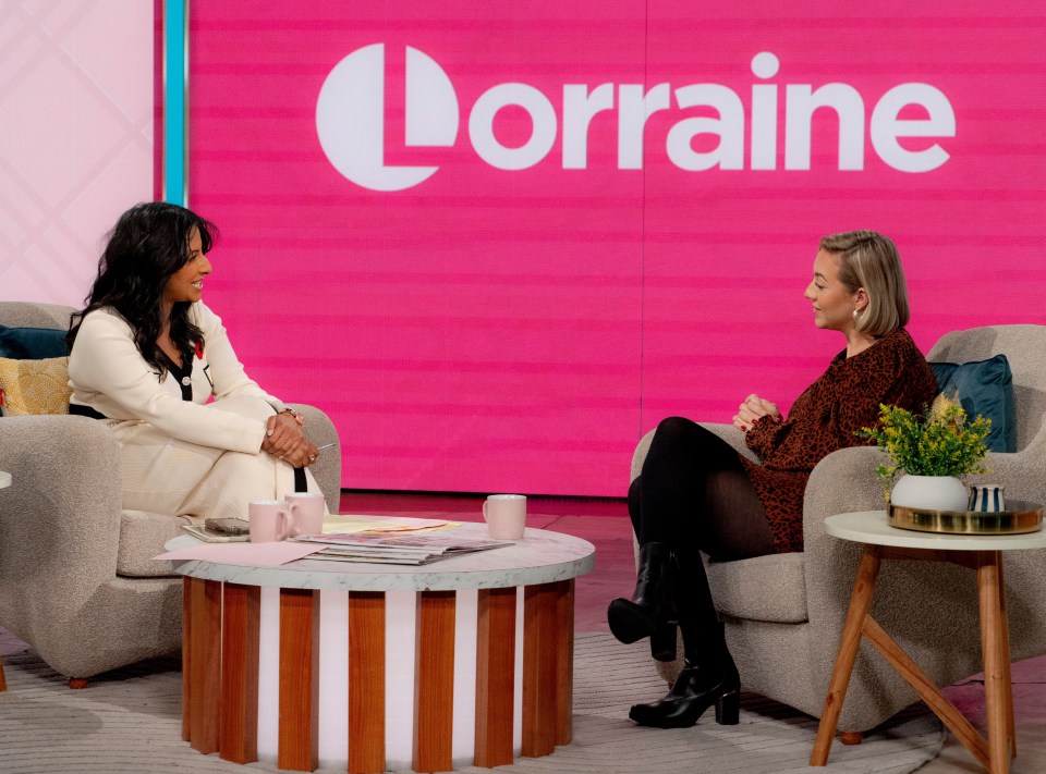 two women are sitting in front of a sign that says lorraine