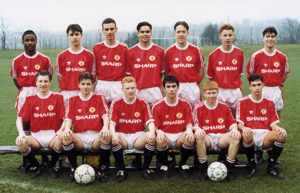 a soccer team poses for a photo wearing sharp jerseys