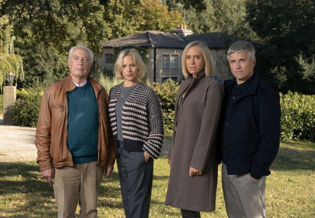 a group of people standing in front of a house