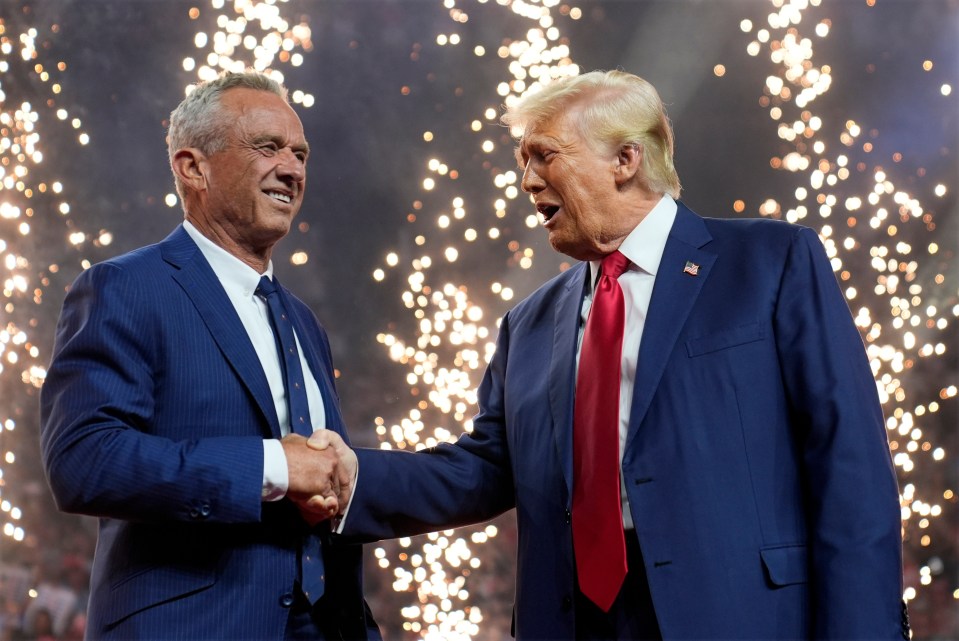 a man in a blue suit shakes hands with a man in a red tie