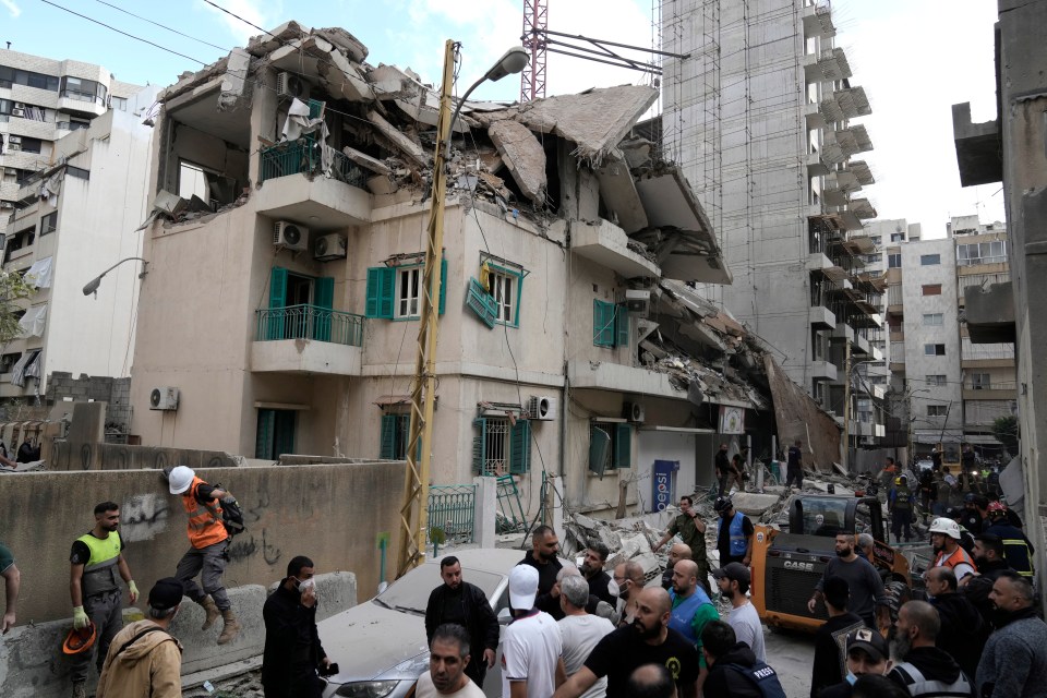 Residents and rescuers gather at the site of an Israeli airstrike that hit a building in central Beirut’s Ras el-Nabaa neighbourhood, Lebanon, on Sunday