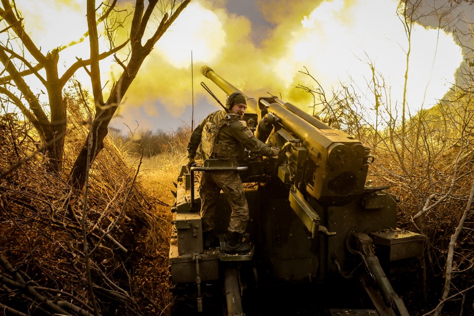 A Ukrainian soldier fires a howitzer towards Russian positions