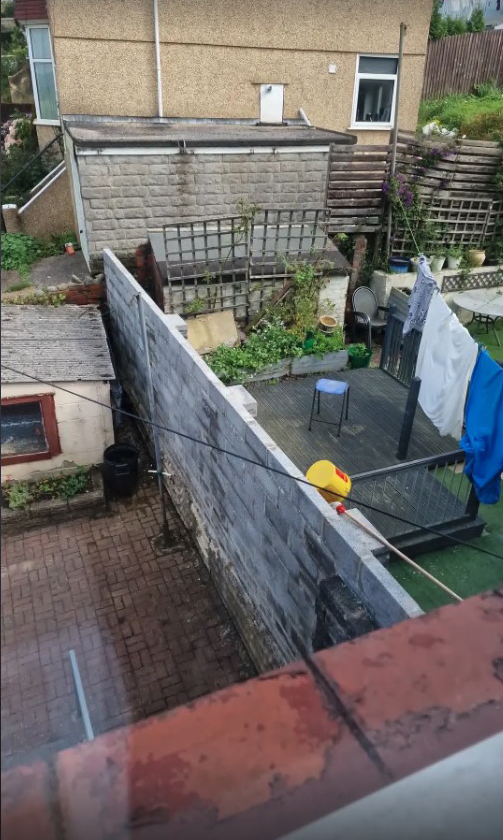 A man has revealed that his neighbour built a huge wall to separate their gardens