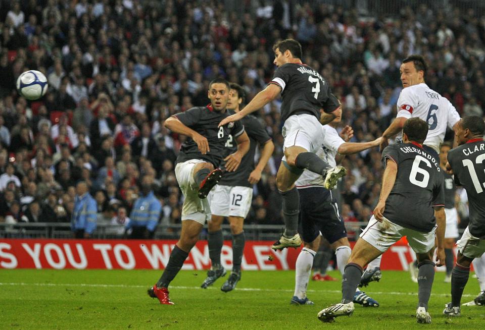 soccer players on a field with one wearing the number 6