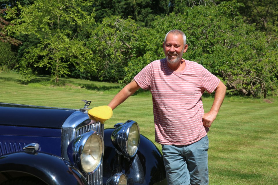 Staff member Sean polishes the Bentley