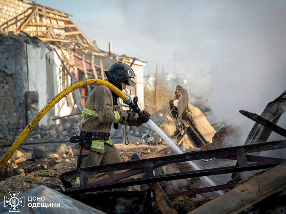 Ukrainian rescuers working at the site of an air strike in Odesa, southwestern Ukraine