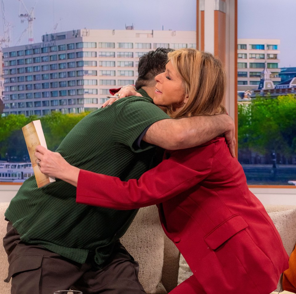 a woman in a red jacket is hugging a man in a green shirt