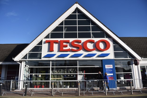 the front of a tesco store with a triangle roof