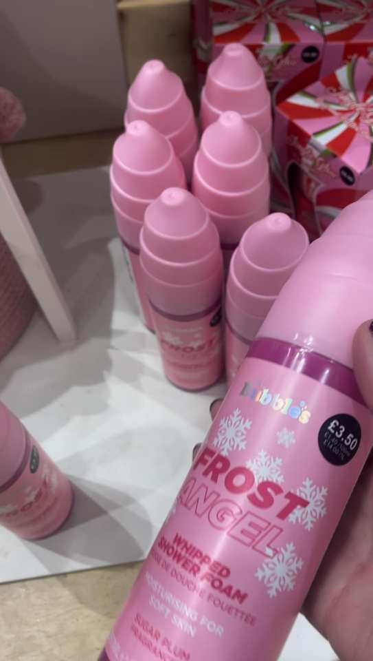 a person is holding a bottle of frost angel whipped shower foam