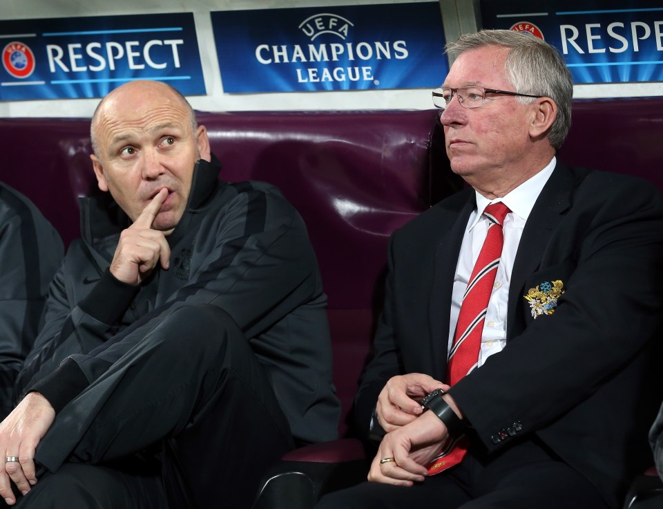 two men sit in front of a uefa champions league sign