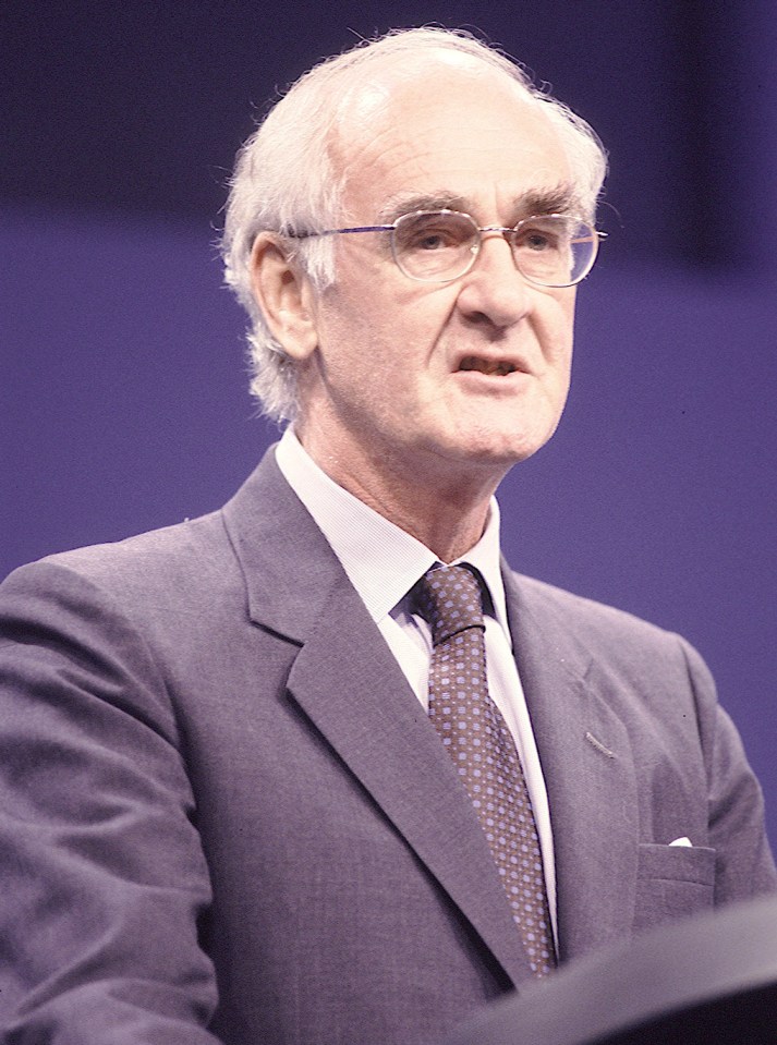 a man in a suit and tie is giving a speech