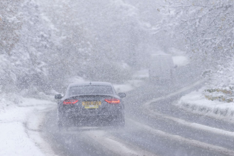 a car driving down a snowy road with a license plate that says ytb gpz