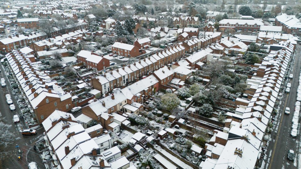 an aerial view of a residential area covered in snow