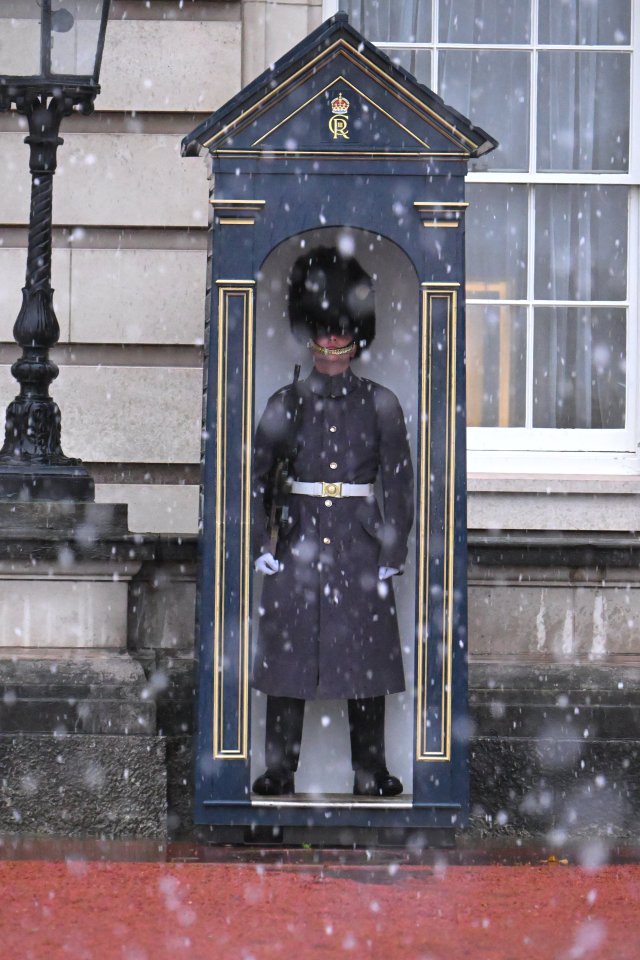 a man in a military uniform stands in front of a building with the letter r on it