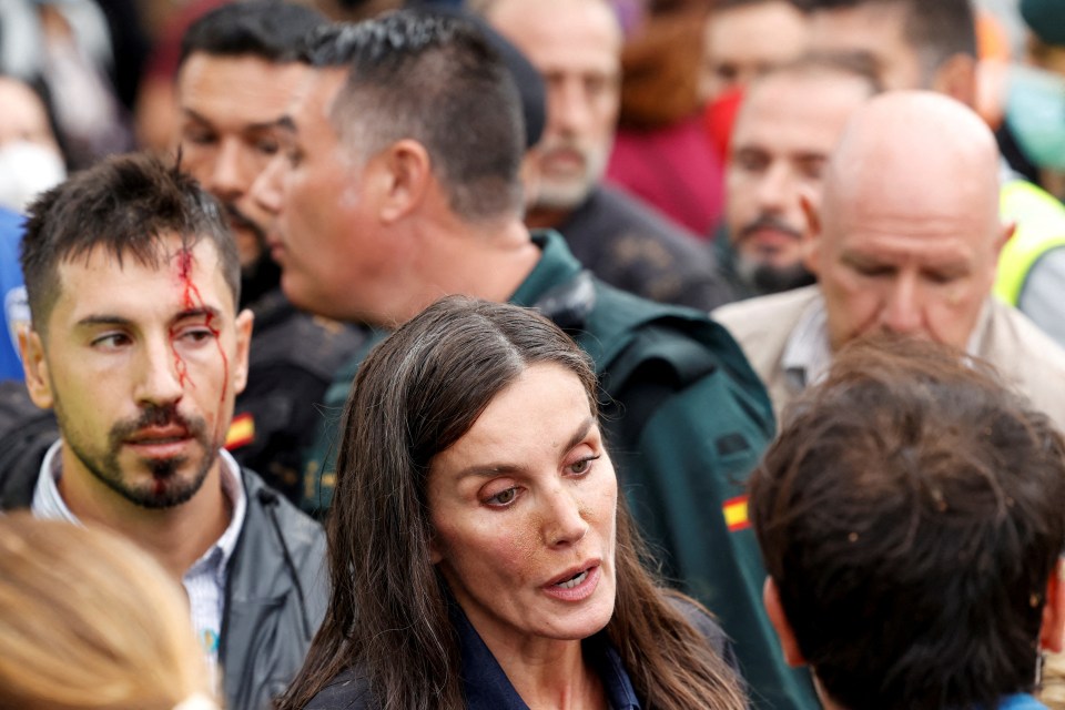 Spain’s Queen Letizia speaks to locals in Paiporta with mud on her face - as a bodyguard behind her has blood all down his face