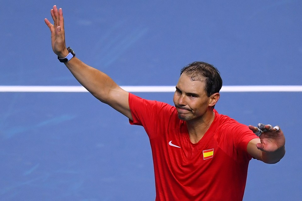 a man wearing a red shirt with a spanish flag on it