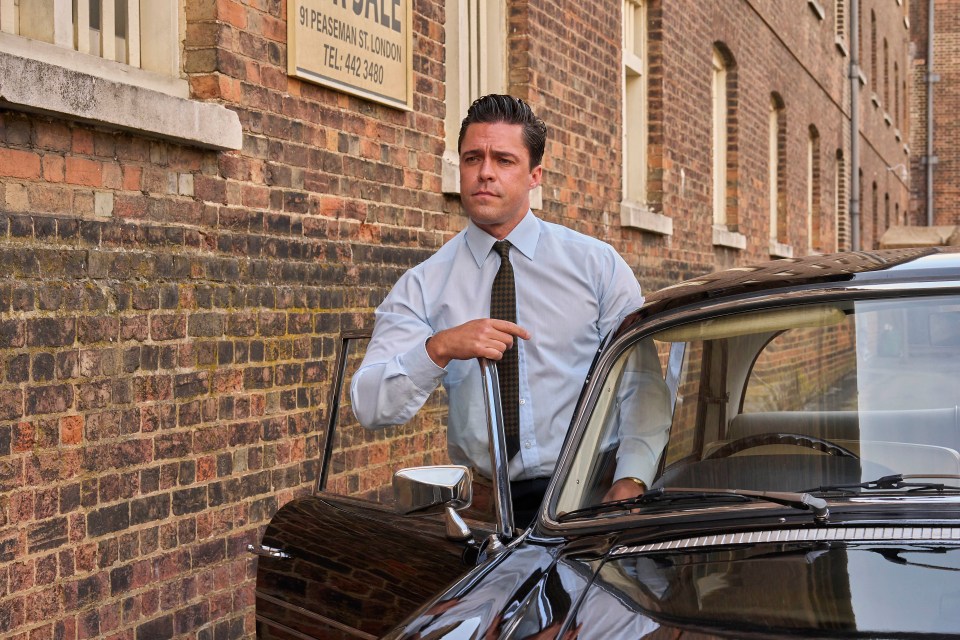 a man stands next to a car in front of a sign that says peabody st london