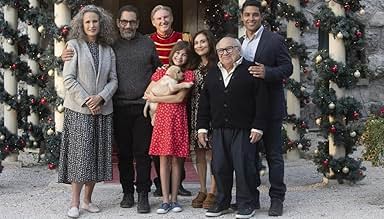 a group of people are posing for a picture in front of a christmas tree .